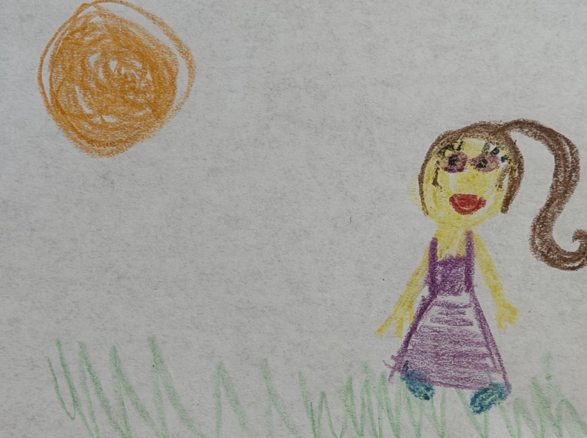 A child's crayon drawing of a girl with a ponytail under an orange sun